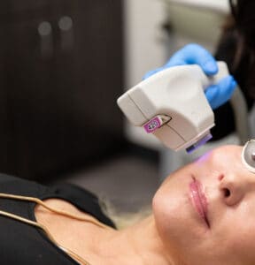 A women receives a treatment from the Sciton Forever Clear device